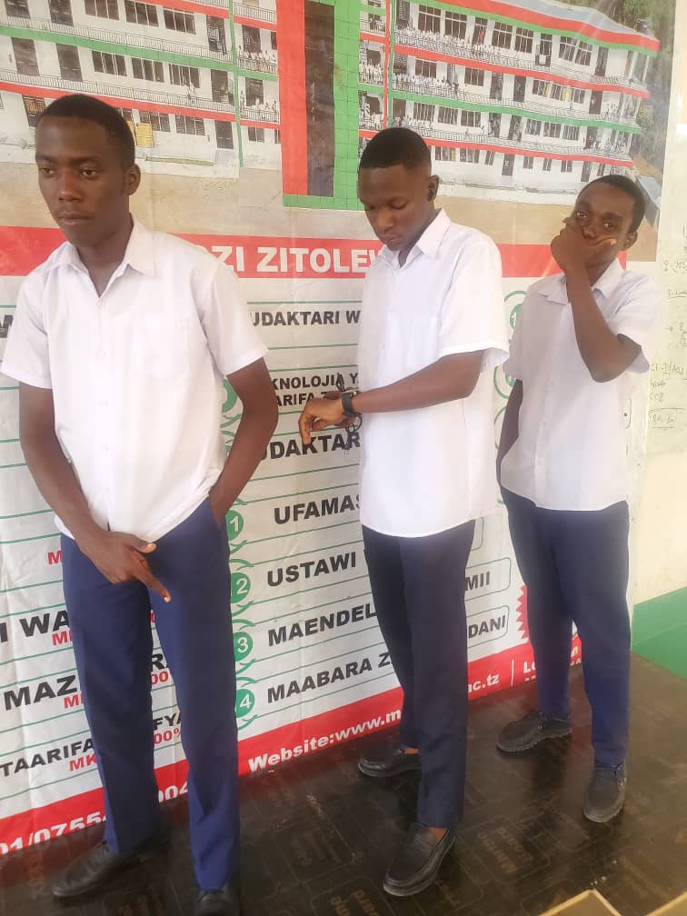 Junior with fellow students at City College Mwanza.