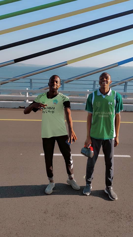 Junior with a friend on the bridge by the lake.