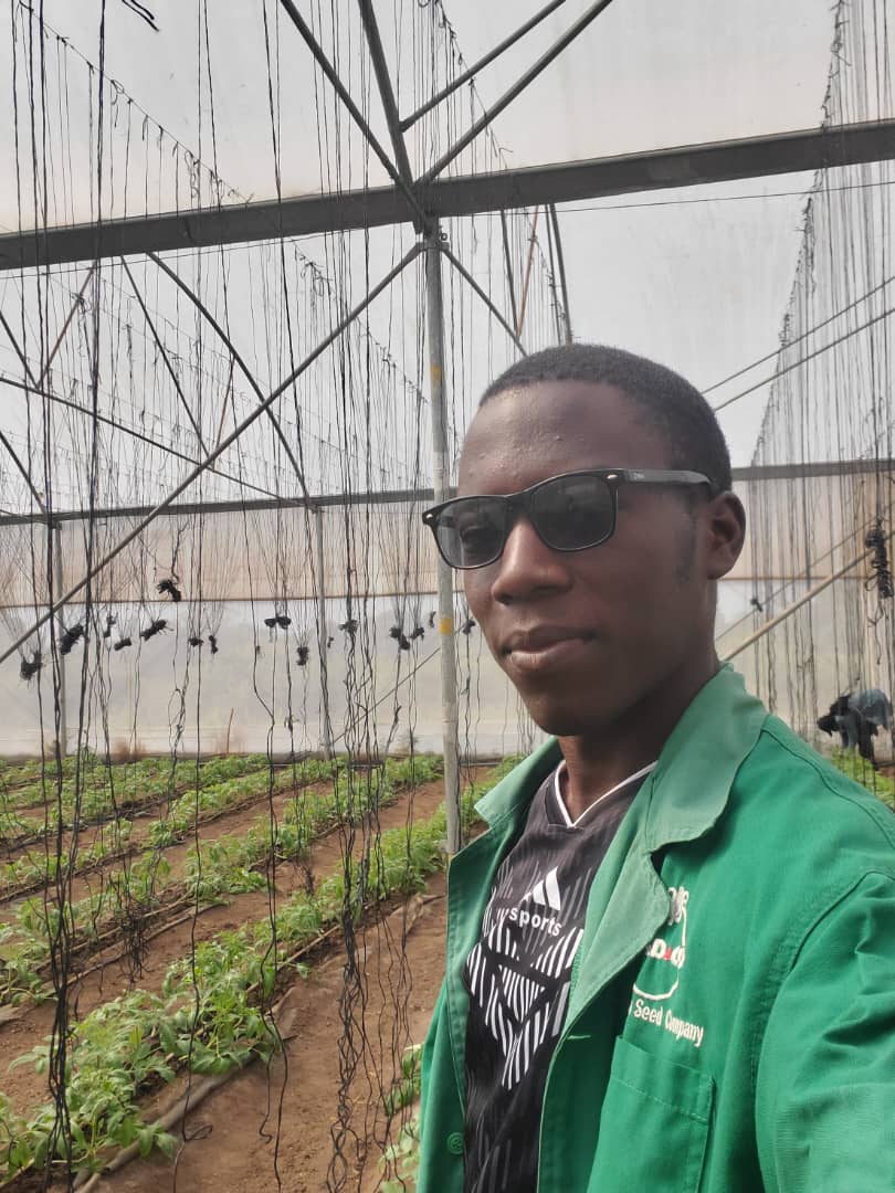 Junior wearing sunglasses inside the greenhouse.