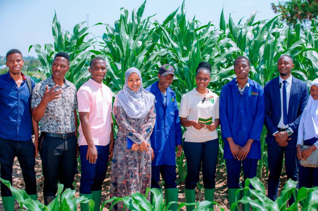 Junior with Madam Zabibu Urassa and fellow students in a maize field.